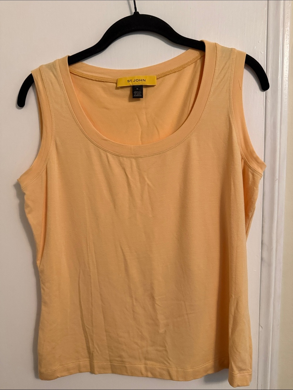 St. John sleeveless top features a classic scoop neckline and a straight hem.